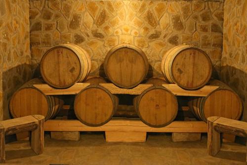 four wine barrels sitting on a table in a room at Captain Ikaros in Agios Kirykos