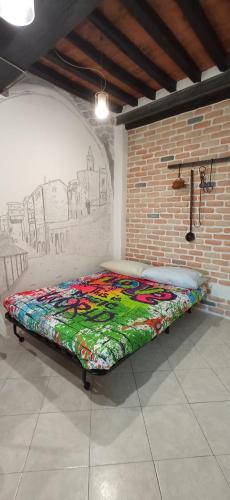 a bed in a room with a drawing on the wall at Sunrise Apartment in Peccioli