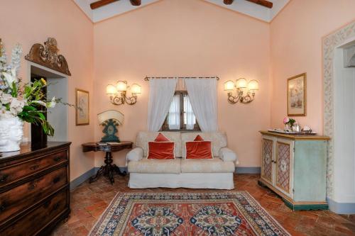 a living room with a couch and a window at Il Falconiere Relais & Spa in Cortona