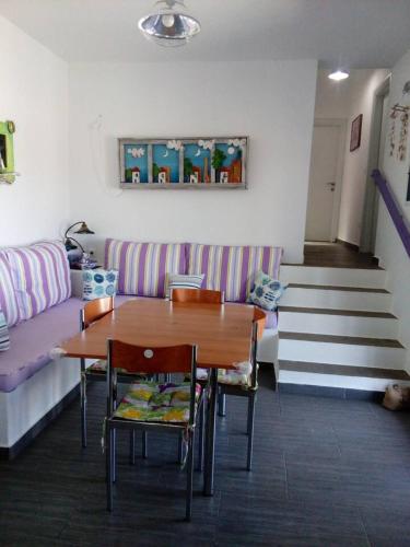 a living room with a table and a couch at Vourkari house in Ioulis