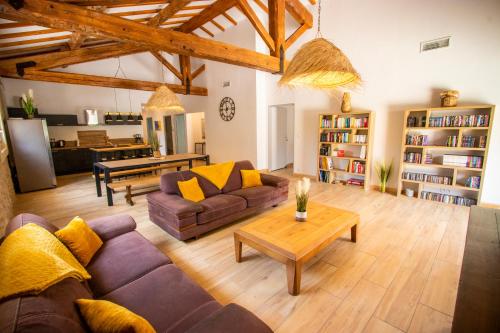 a living room with a couch and a table at Gîte du Montagut in Thézan-des-Corbières