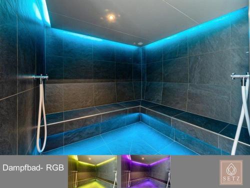 a bath tub with blue lights in a bathroom at Apart Austria in Nauders