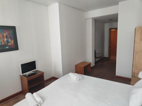 מיטה או מיטות בחדר ב-House Rooms in Bairro Alto
