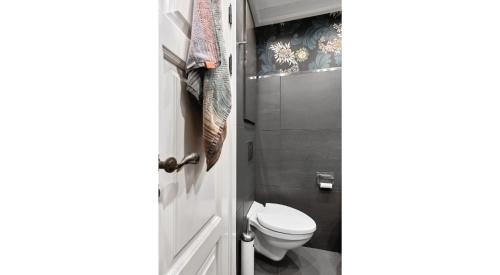 a bathroom with a white toilet in a room at Solsiden - in the center of Geilo in Geilo