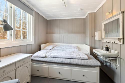 a small bedroom with a bed and a sink at Solsiden - in the center of Geilo in Geilo