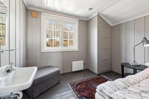 a bedroom with a sink and a bed and a window at Solsiden - in the center of Geilo in Geilo