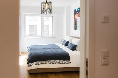 a bedroom with a bed and a window at Hamilius Apartments City Center Luxembourg by Rentaroo in Luxembourg