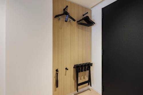 a hallway with a door with hangers and shoes at Fairfield by Marriott Hokkaido Minamifurano in Minamifurano