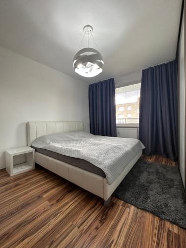 um quarto com uma cama e cortinas azuis em Apartrip Komenskeho em Košice