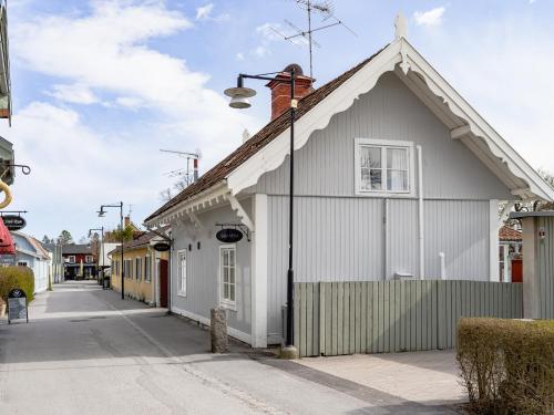 a white building on a street with a street light at Villa Vega in Trosa