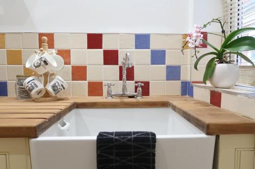 a kitchen with a sink and a counter top at Bourne House, private modern apartment near Rugby & Lutterworth 