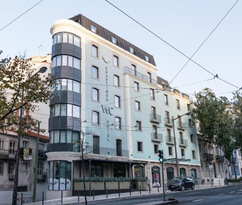 a large white building on a city street at WC by The Beautique Hotels in Lisbon