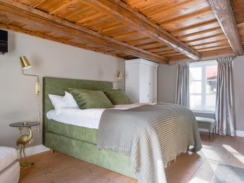 a bedroom with a large bed and a wooden ceiling at Villa Vega in Trosa
