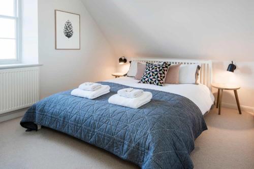 a bedroom with a bed with two towels on it at Upper Seaton in Salcombe