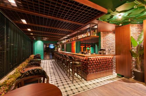 a restaurant with a bar with wooden tables and chairs at Azuu Boutique Hotel in Antalya