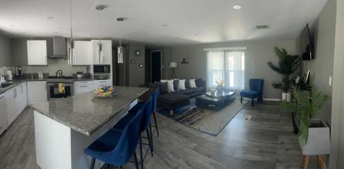 a kitchen and living room with a table and blue chairs at Sedona Vista To Red Rock pets friendly and Hot Tub coming MAY! in Sedona