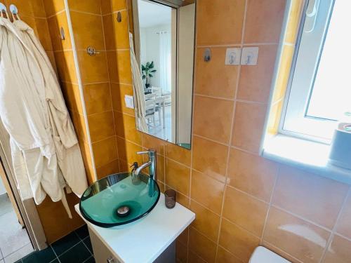 a bathroom with a green sink and a mirror at Cozy Nest - 2min To Beach, 6min Walk To Old Town in Chania Town