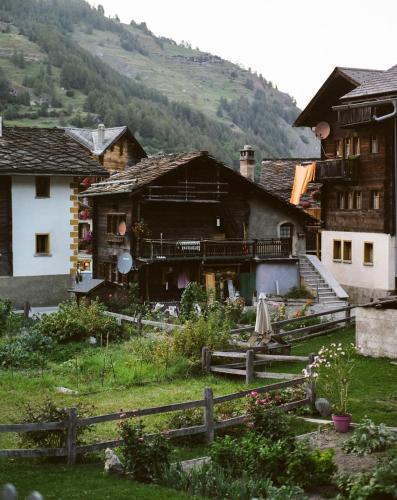a group of buildings with mountains in the background at Hôtel Dents de Veisivi in Haudères