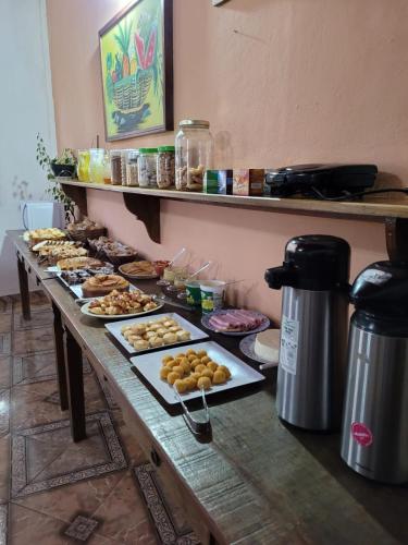a table with many different types of pastries on it at Pousada Santo Expedito in Tiradentes