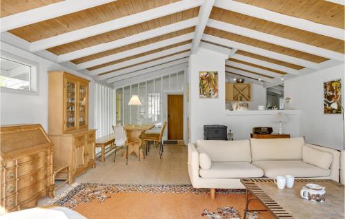 a living room with a white couch and a table at Holiday Home Ringgårdsvej in Hornbæk
