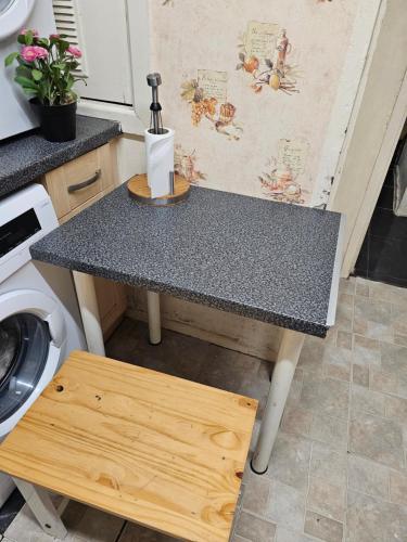 a table in a kitchen with a washing machine at Axel Rooms 3 in Manchester