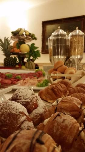 a bunch of pastries on plates on a table at Hotel Villa Degli Angeli in Castel Gandolfo