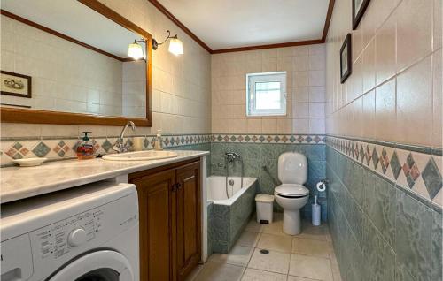 a bathroom with a sink and a washing machine at Nice Home In Mantineia Messinia With Wifi in Kitriaí