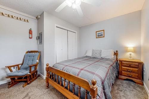 a bedroom with a bed and a chair at Downtown Beauty - Unit 1 in Conway