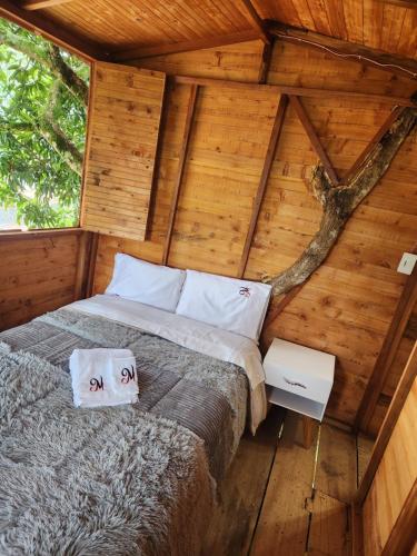 a bedroom in a tree house with a bed at Villa Mimosa Finca Hotel in Quimbaya