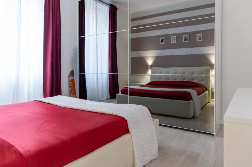 a bedroom with two beds and a mirror at Myro's House in La Spezia