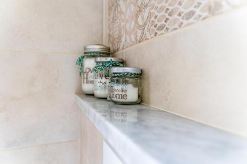 a shelf with jars on it in a bathroom at Myro's House in La Spezia