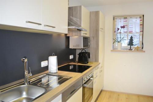 a kitchen with a sink and a counter top at Ferienwohnungen Anja in Steeg