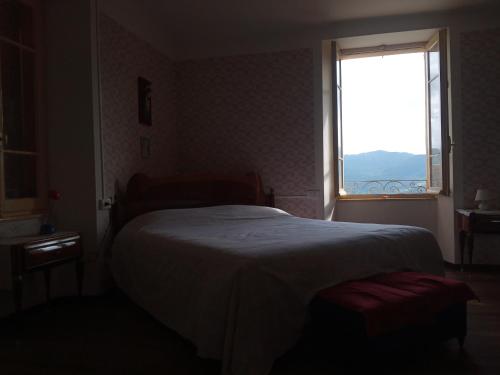 a bedroom with a large bed with a large window at Villa Giulia in Lura