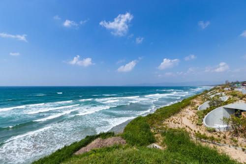 an aerial view of the ocean on a sunny day at Izumo HOTEL THE CLIFF in Kumura