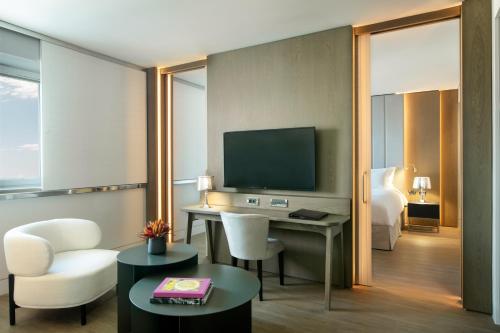 a hotel room with a desk and a television at Sofitel Athens Airport in Athens