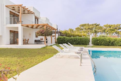 a villa with a swimming pool and a house at Villa Santa Maria with private pool and sea view in Afantou
