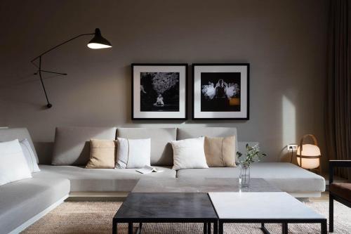 a living room with a white couch and a table at Hotel Peralada Wine Spa & Golf in Peralada