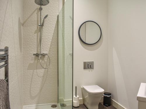 a bathroom with a shower with a toilet and a mirror at Apartment 1 - Ukc6766 in Arbroath
