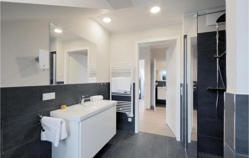 ein Badezimmer mit einem weißen Waschbecken und einem Spiegel in der Unterkunft Baltischer Hof Apartment 67 in Boltenhagen