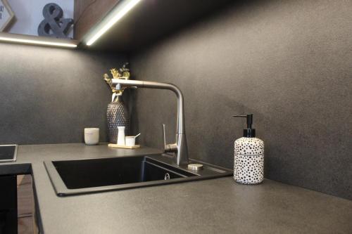 a kitchen sink with a faucet on a counter at Haus Eder in Ginzling