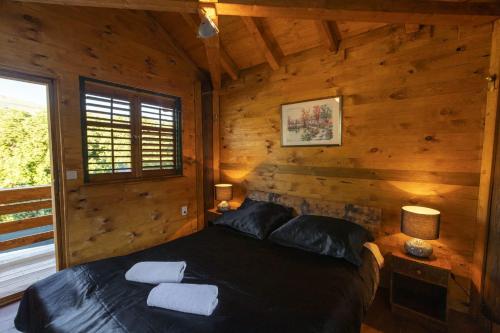 - une chambre avec un lit dans une cabane en rondins dans l'établissement Luxury villa resort Ordulj with heated pools,12-16 pax, à Srinjine