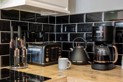 a kitchen counter with a toaster and a coffee maker at Gorgeous House with BBQ Patio in Great Yarmouth
