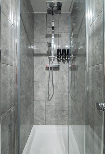 a bathroom with a shower with a glass door at Gorgeous House with BBQ Patio in Great Yarmouth