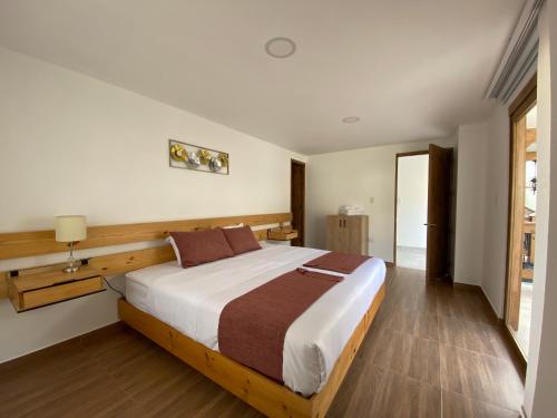 a bedroom with a large bed in a room at Hotel Gran Plaza San Agustin in San Agustín