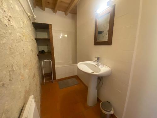 a white bathroom with a sink and a bath tub at Studio 1 lit 140cm et 1 lit 90cm in Saint-Mézard