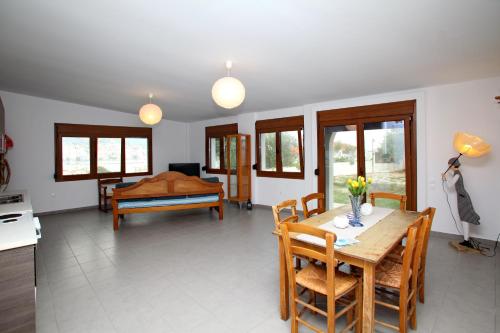 a kitchen and dining room with a table and chairs at Finikas Apartments in Skopelos Town