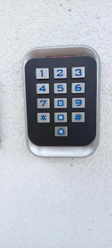a remote control attached to a white wall at Duplex Holiday Apartment in Škofljica