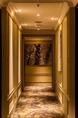 an empty hallway with green walls and a ceiling at Signature by M Village Hai Bà Trưng in Ho Chi Minh City