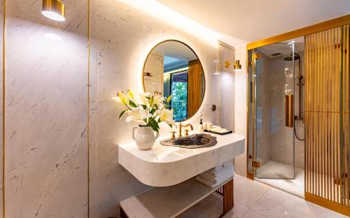 a bathroom with a sink and a mirror at Signature by M Village Hai Bà Trưng in Ho Chi Minh City