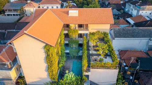 an aerial view of a house with a swimming pool at Tanaga CoLiving in Seminyak